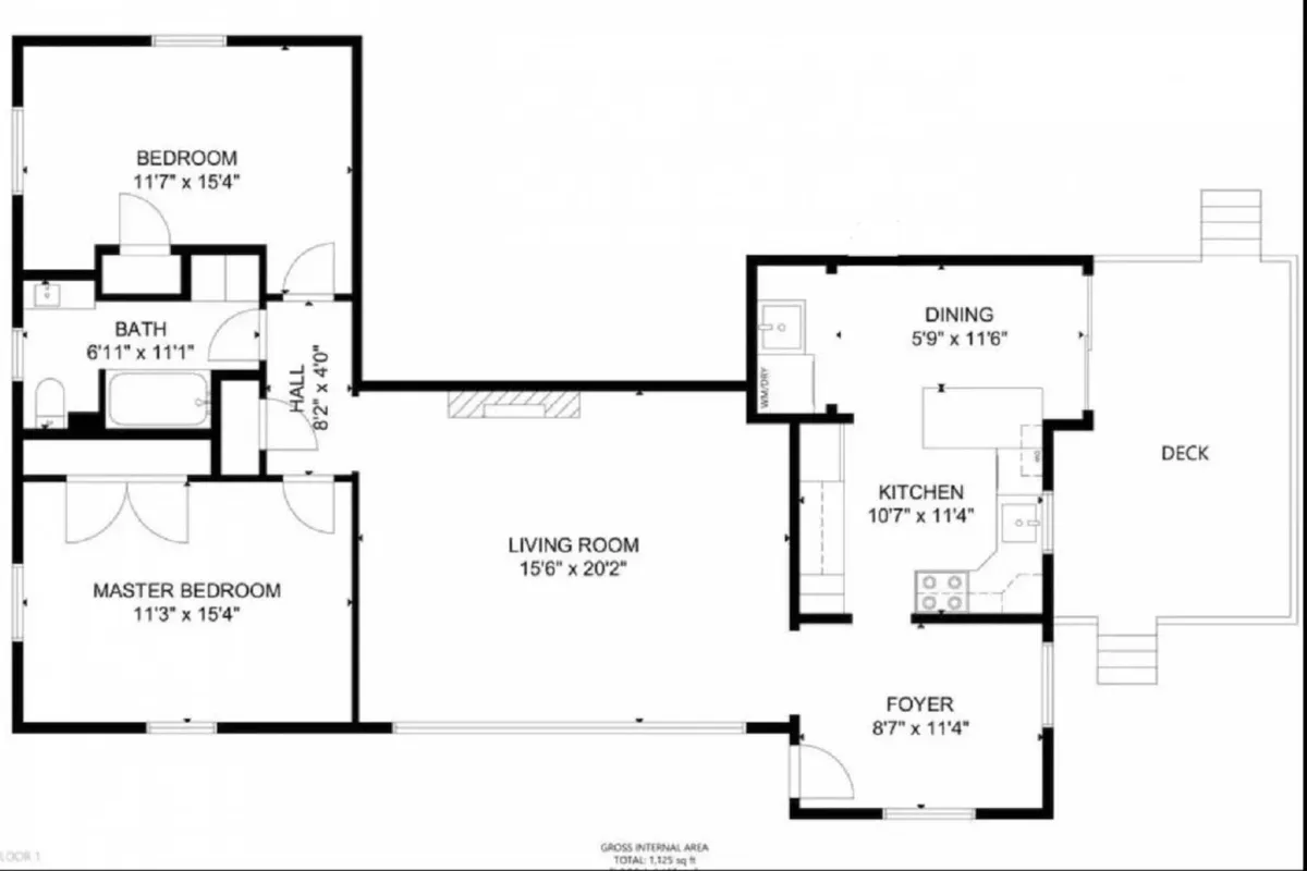 An open layout view that connects the living room, kitchen, master bedroom, and deck. The living room is set up for family gatherings, movie nights, and relaxation, while the visible kitchen and deck hint at the home's flow and versatility for group activities and coastal living.